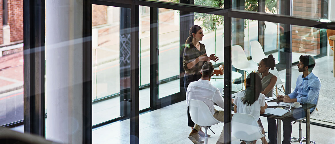Group of employees holding a meeting with their supervisor on workplace violence prevention