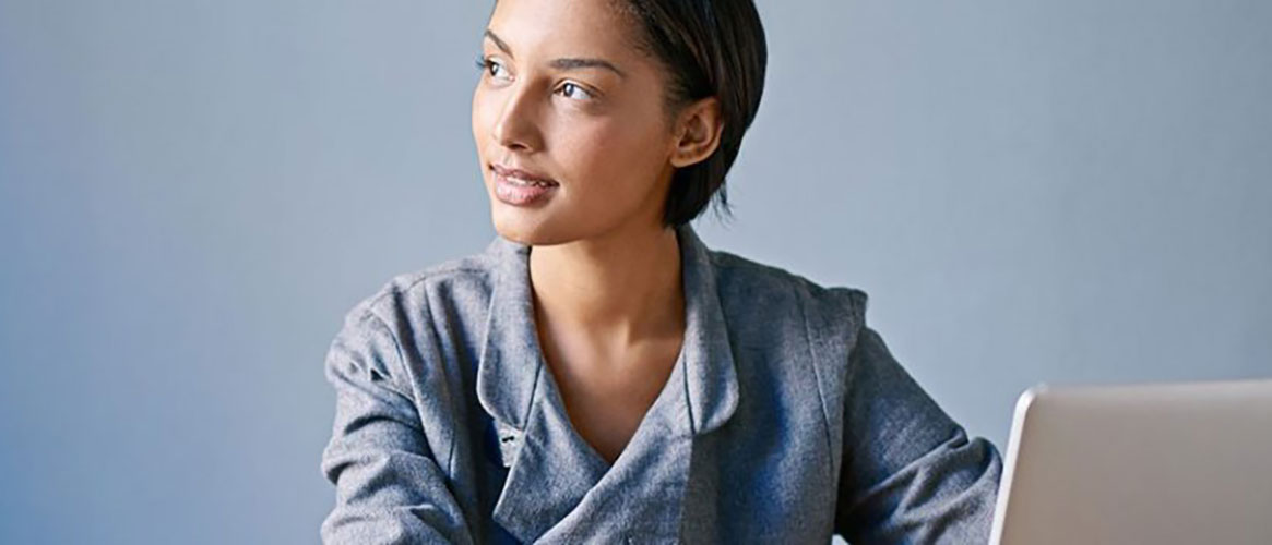 Woman showing how to implement the 20-20-20 rule: every 20 minutes, look at something 20 feet away for 20 seconds