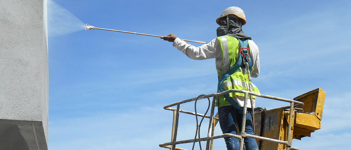 person washing a window on an aerial platform