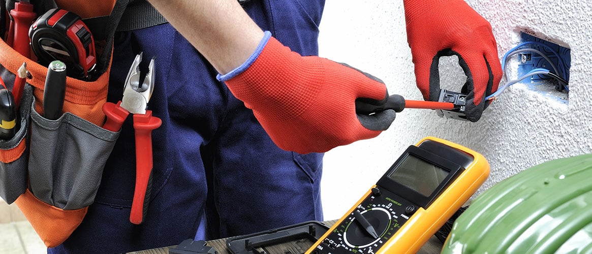 Young electrician technician works in compliance with safety standards in a residential electrical system