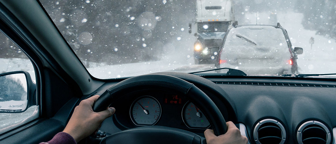 Person driving in winter traffic