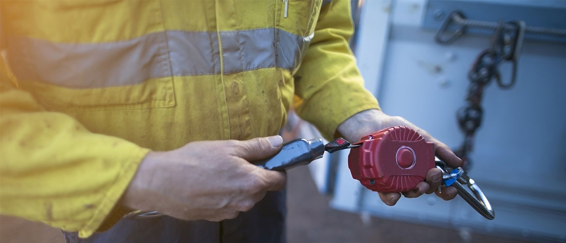 Construction worker inspecting fall prevention equipment