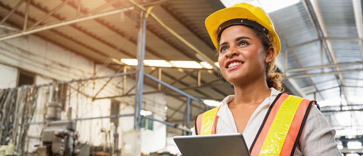 Industrial worker checking on equipment to make sure it functions properly and safely