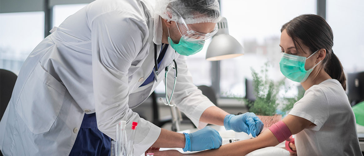 Medial professional administering an immunization to a patient