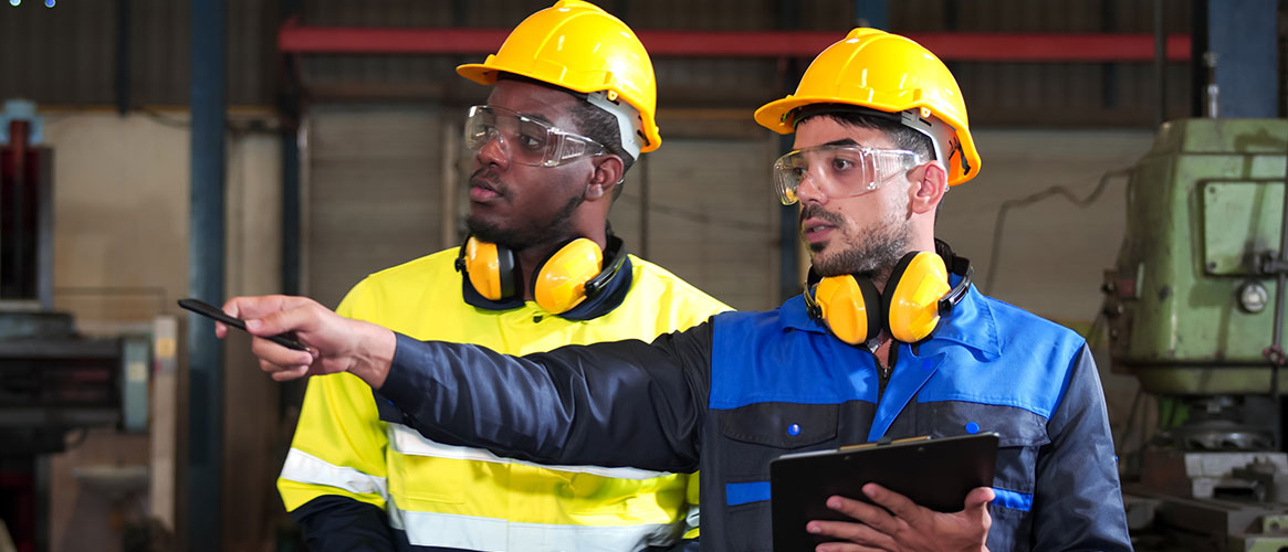 Employees conducting an inspection of the workplace and documenting findings as part of a job hazard analysis