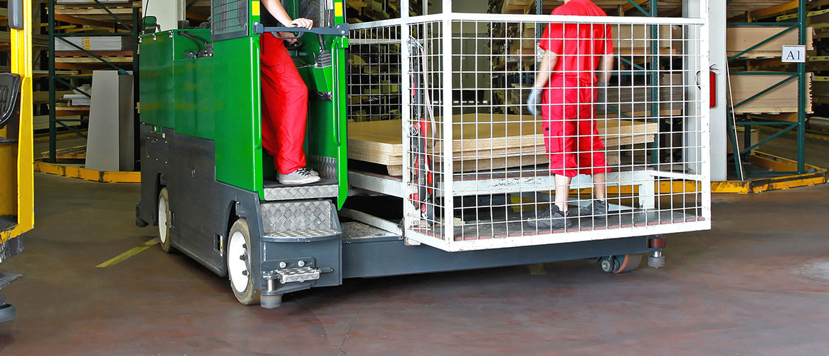 Worker about to be elevated on a forklift platform by the operator of the forklift.