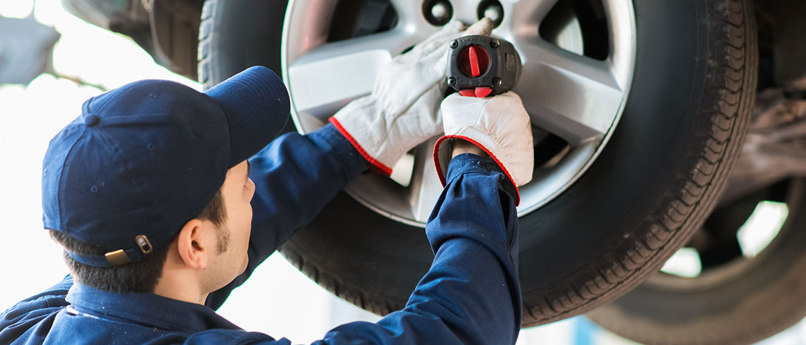 Mechanic wearing protective gloves to ensure proper grip on the tool he is using
