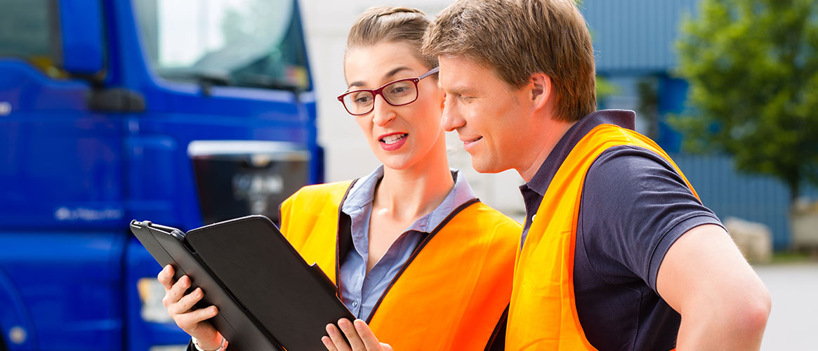 workers looking at fleet vehicles