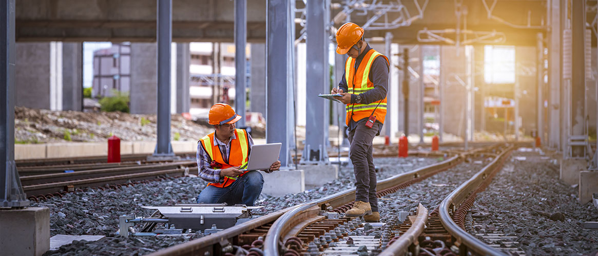 people working on railway tracks
